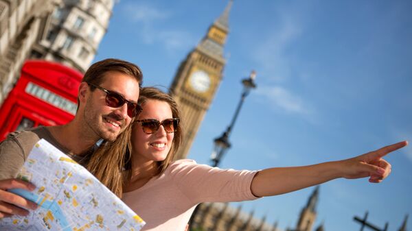 Young couple as tourists looking for the way on the map.