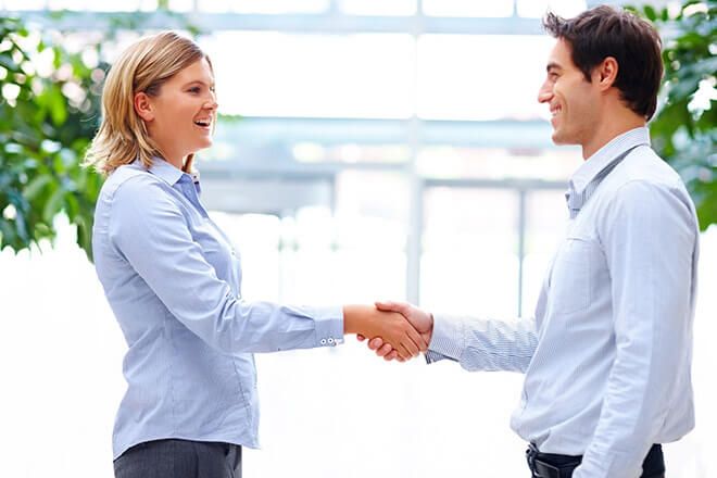 Man and woman holding hands and laughing.