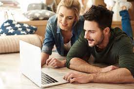 A young couple looks at apartments on the Prestige Group website.